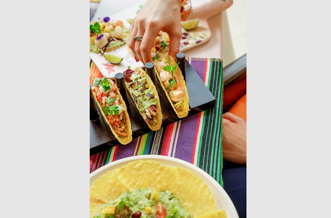 Gulf Weekly Delight in tender tortillas and creamy guacamole at Taco Fiesta